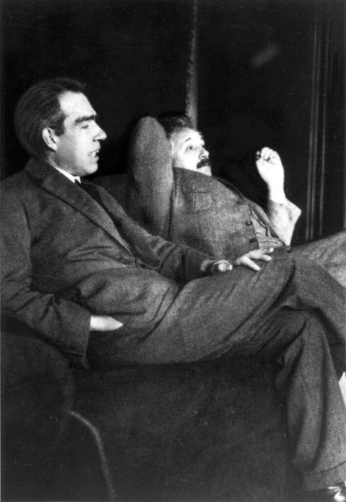 albert einstein and niels bohr, casual, discussion, 20th century personalities, niels henrik david bohr, niels bohr danish physicist, einstein theoretical physicist, genius, celebrity, personality, person, people, famous man, famous men, big man, einstein 1879-1955, 76 years old, niels bohr 1885-1962, 77 years old, black and white photo