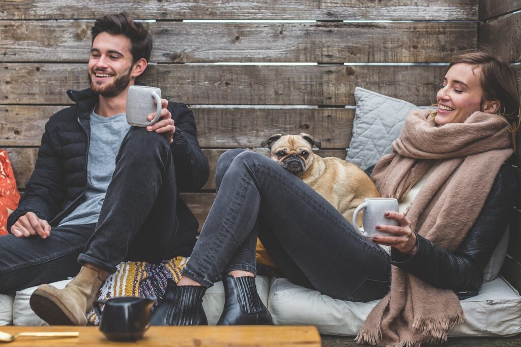 merry christmas, man, woman, dog, pet, pug, owners, couple, relationship, warm clothes, cozy, scarf, jackets, jeans, boots, fashion, people, happy, love, female, young, male, adult, caucasian, happiness, romantic, portrait, smile, smiling, girlfriend, date, animal, boyfriend, together, person, lovers, sitting, relaxing, rustic, cushions, couch, laughing, enjoying, coffee
