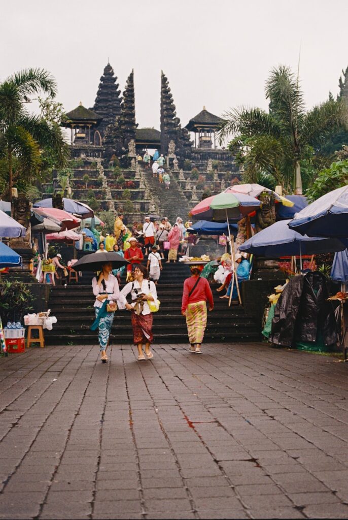 People walk toward a traditional temple.