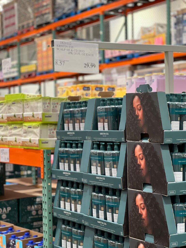 Haircare products displayed in a warehouse aisle, organized on shelves.