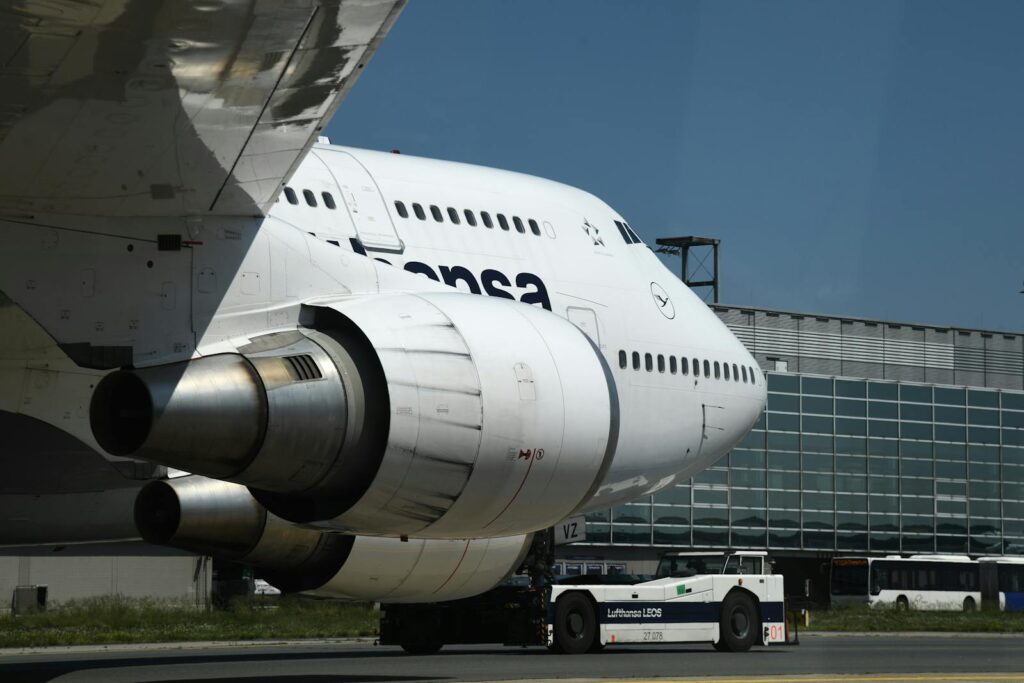 Lufthansa Boeing 747 aircraft taxis at Frankfurt Airport on a clear day.