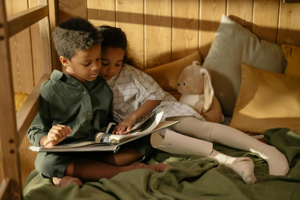Two children reading together in a cozy room, capturing sibling love and togetherness.