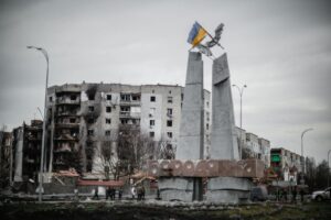 A monument stands beside war-torn buildings in Borodyanka, Ukraine.