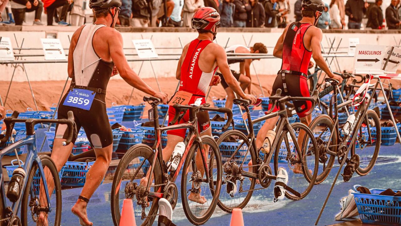 Athletes transition from swimming to cycling at a triathlon event.