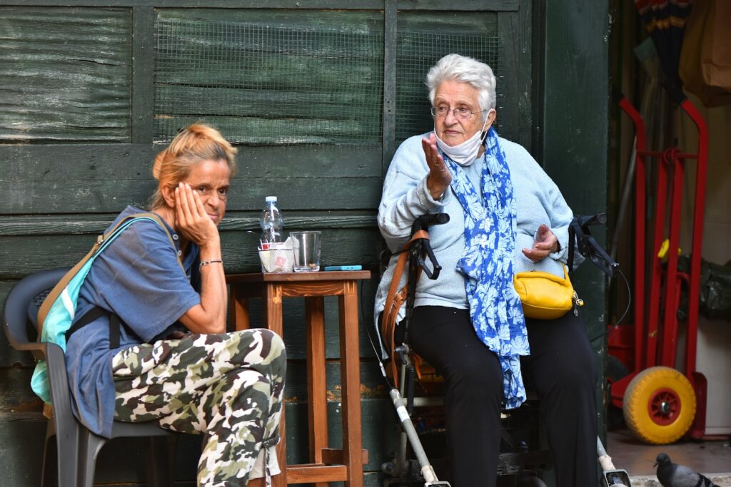 a woman sitting next to a woman sitting at a table