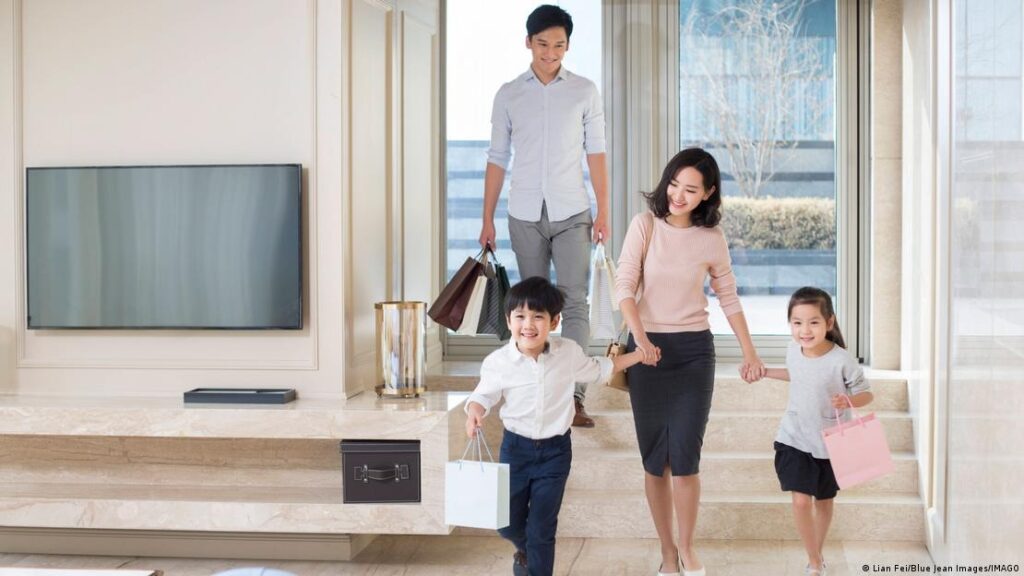 A family arrives home after shopping in Beijing, China, on May 13, 2025
