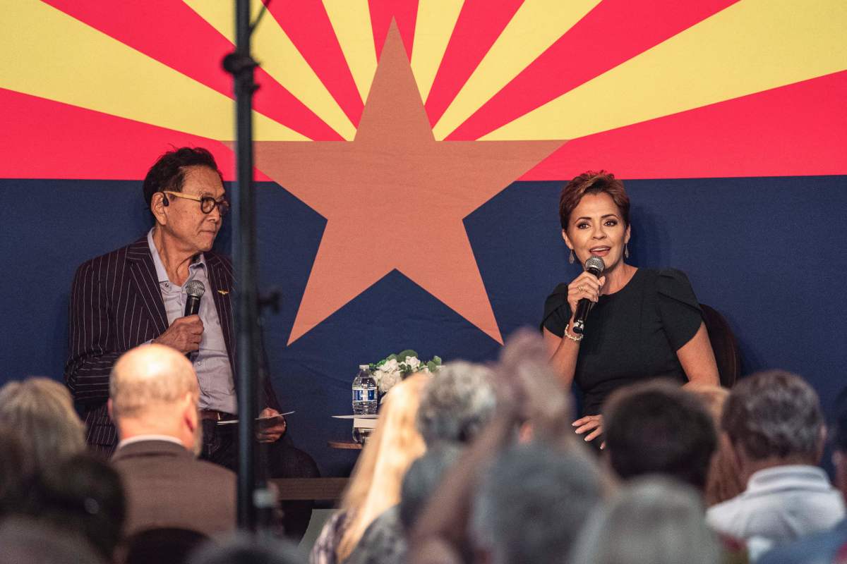 Republican candidate for Governor of Arizona Kari Lake (R), flanked by US businessman Robert Kiyosaki, answers questions written in advance during her Ask Me Anything Tour in Sun City, Arizona, on October 21, 2022.