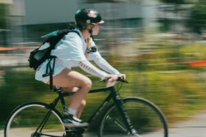 A woman riding a bike down a street