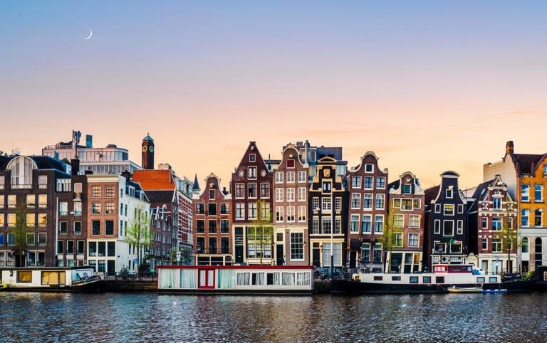 The slender town houses which line the many canals of Amsterdam are a key symbol of the city - Karl Hendon